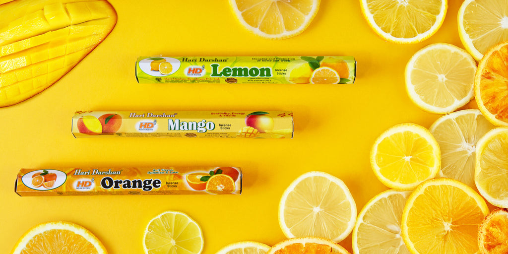 A selection of citrus fruits with lemon, mango and orange flavour incense packets.